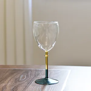 Elegant creative color-blocked wine glass featuring an amber stem and dark green base