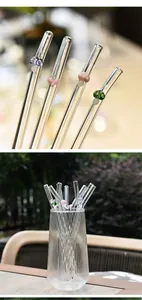 Close-up of reusable borosilicate glass straws with cute colorful mushroom decorations.