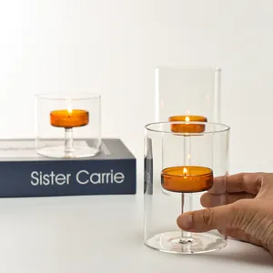 European cylindrical glass candle holder set with amber cup and warm candle light