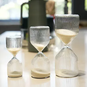 Set of three ribbed glass hourglasses in 5, 15, and 30 minute sizes for home decor