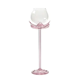 Elegant pink lotus-shaped long stem glass for wine or cocktails on white background