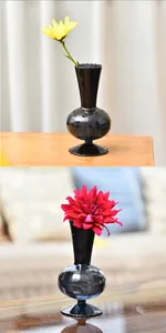 Grey smoke glass vase for flowers, elegant ribbed design on dark reflective table