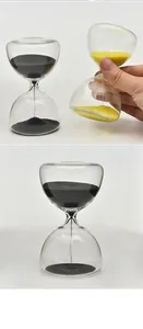 Close-up of minimalist 5-minute glass hourglasses with black and yellow sand decor