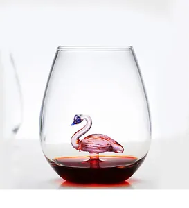 Close-up of a creative glass cup with a 3D pink flamingo glass sculpture inside