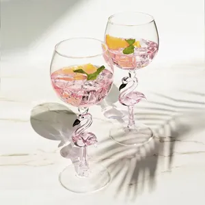 Elegant flamingo stem wine glass set with pink cocktail and tropical palm shadows