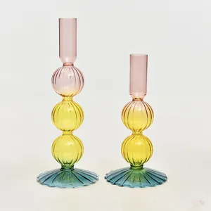 Elegant set of two colorful vintage style glass candle holders for home table decor.