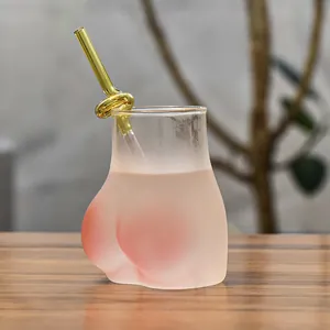 Creative butt-shaped frosted glass cup with pink gradient and decorative gold knot straw
