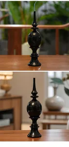 Detailed view of a black Zen style incense holder with elegant smoke rising on a table