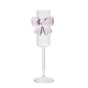 Elegant champagne flute with creative pink glass bow decoration for romantic occasions
