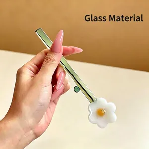 Handmade green glass coffee stirrer with a cute white flower charm for desserts