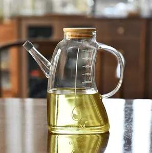 Macro view of 1000ml glass oil dispenser bottle with bamboo lid and scale marks