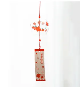 Macro detail of a Japanese Edo-style handmade glass wind chime with cute apple motifs