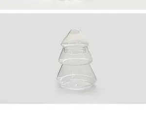 Detailed view of the clear glass Christmas tree-shaped storage jar with its matching lid.