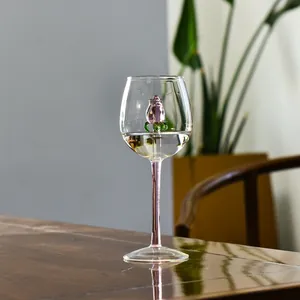 Dettaglio di un calice da vino creativo con una rosa in vetro 3D fatta a mano in rosa