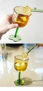 Detailed view of an amber flower-shaped glass goblet with a matching glass stirrer