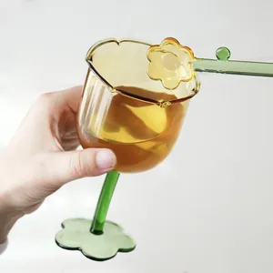 Creative tulip-shaped amber glass wine cup with a green flower base and stirrer.