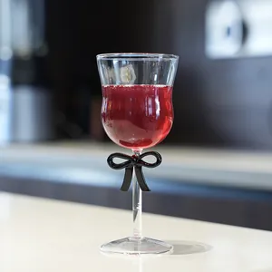 Elegant vintage wine glass with a decorative black bow on the stem.