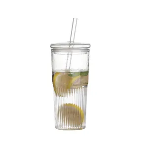 Elegant transparent textured glass cup with straw and lid, featuring fresh lemon infusion