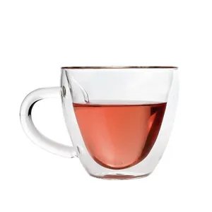 Elegant heart-shaped double-walled glass cup for coffee or tea with a clear handle.