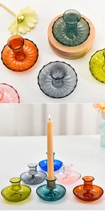 Elegant assorted colorful glass candle holders displayed on a white tabletop for home decor.