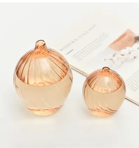 Detailed view of two elegant champagne ribbed glass vases with spiral texture on white