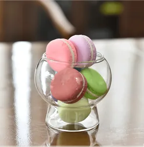 Close-up view of a creative ins-style clear glass dessert cup filled with colorful macarons
