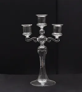 Detailed macro view of an elegant three-armed clear glass candelabra for home decor
