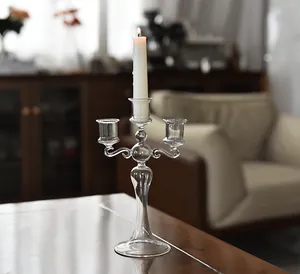Elegant three-arm French glass candelabra with a lit candle for home decor