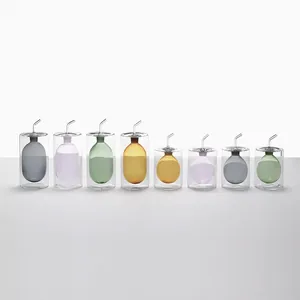 Modern double-walled glass oil and vinegar dispenser set with colorful inner bottles
