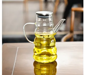 Detailed view of the wavy glass oil dispenser with stainless steel lid and spout