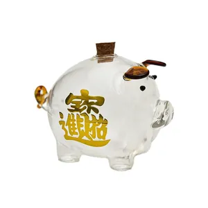Hucha de cristal transparente con caligrafía dorada y tapón de corcho para monedas u oro.