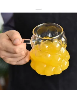 Detailed macro view of the unique bumpy grape texture on a clear glass mug with handle