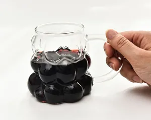 Detailed macro view of a creative grape shaped glass mug featuring a sturdy handle