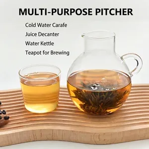 Close-up of a heat-resistant glass pitcher and cup set with blooming tea on wood.