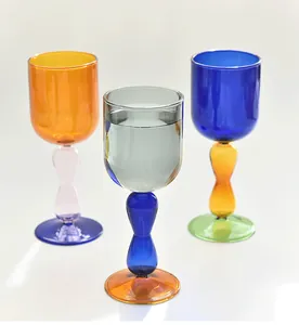 Collection of three colorful glass goblets featuring vibrant contrast stems and bases