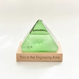 Elegant green pyramid storm glass weather forecast bottle with a wooden base for desk decor