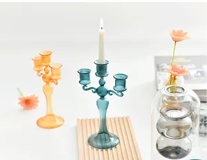 Close-up of elegant blue French glass candelabra with lit candle in a lifestyle setting