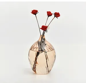 Elegant champagne glass vase with ribbed texture and red roses in water.