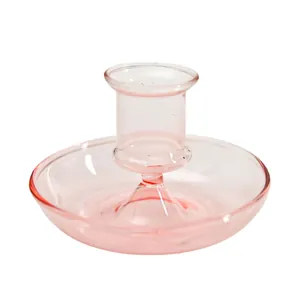 Elegant pink glass candle holder with a wide base for tabletop decor