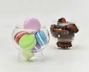 Elegant clear glass dessert bowl filled with colorful macarons on white background