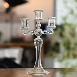 Elegant three-arm clear glass candelabra for romantic dinners and wedding table decor