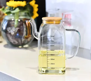 Functional close-up view of a glass oil dispenser with bamboo lid and 750ml scales.
