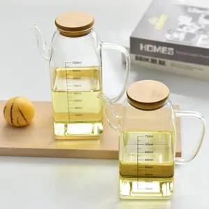 Detailed view of a glass oil dispenser set featuring measurement scales and bamboo lids