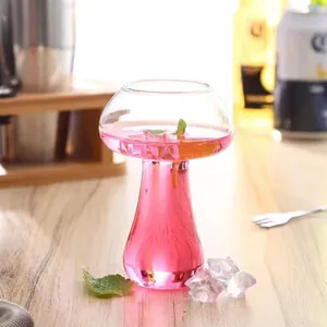 Detailed macro view of a mushroom-shaped glass filled with a pink cocktail and mint