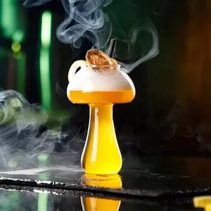 Creative mushroom-shaped cocktail glass filled with yellow drink and dramatic smoke effect