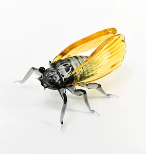 Detailed view of a creative glass cicada ornament with amber wings for home decor