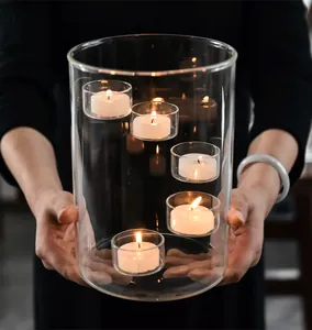 Detailed view of a large clear glass candle holder featuring floating tea light cups