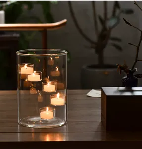 Detailed close-up of a multi-level glass candle holder with glowing warm tea lights.