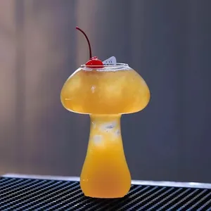 Unique mushroom-shaped glass cocktail cup filled with orange juice for bars and home decor