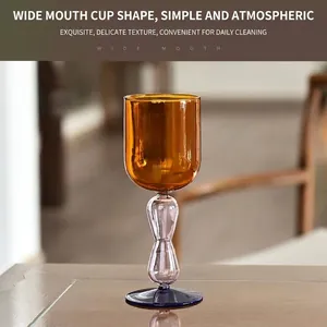 Elegant color-blocked amber glass wine goblet with a creative bulbous stem design